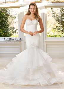 Show stopping strapless crepe fishtail dress with a ruffled skirt